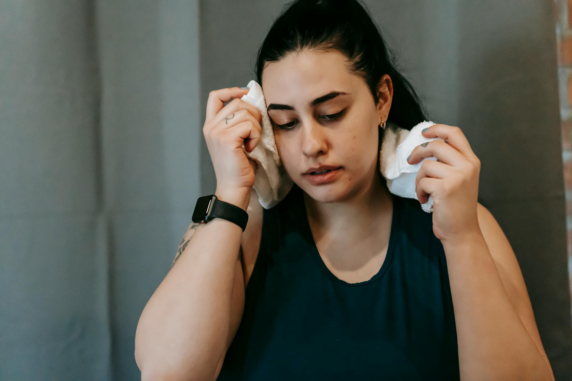 a young woman using a towel at the gym